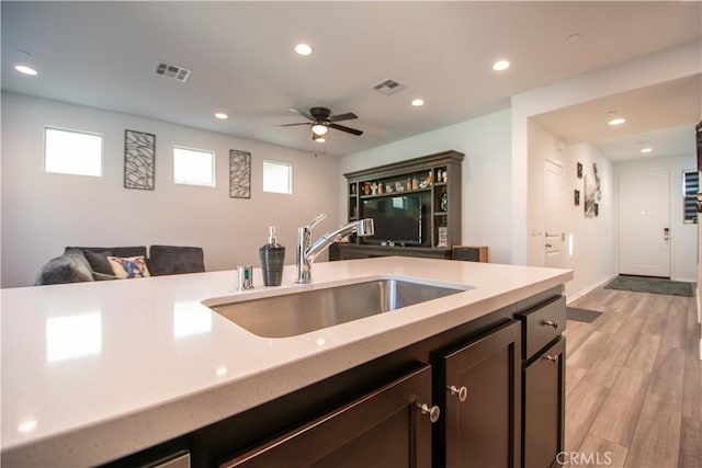 29392 Tourmaline Way, Winchester, CA 92596 - kitchen with light wood finished floors, recessed lighting, open floor plan, ceiling fan, and dark brown cabinets