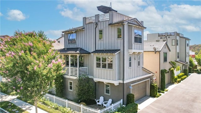 38 Marisol St, Rancho Mission Viejo, CA 92694 - view of front facade featuring board and batten siding, driveway, a garage, a standing seam roof, and a metal roof