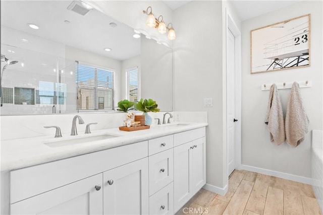 38 Marisol St, Rancho Mission Viejo, CA 92694 - bathroom with double vanity, wood finished floors, tiled shower, and recessed lighting