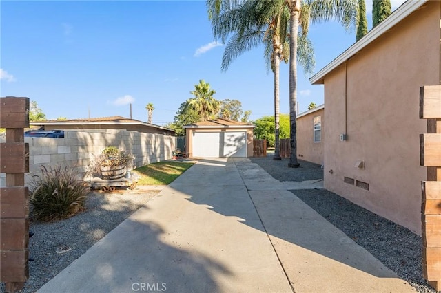 8626 Stark St, Riverside, CA 92504 - view of home's exterior featuring stucco siding, a garage, an outbuilding, and crawl space