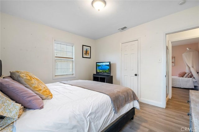 8626 Stark St, Riverside, CA 92504 - bedroom with wood finished floors and baseboards