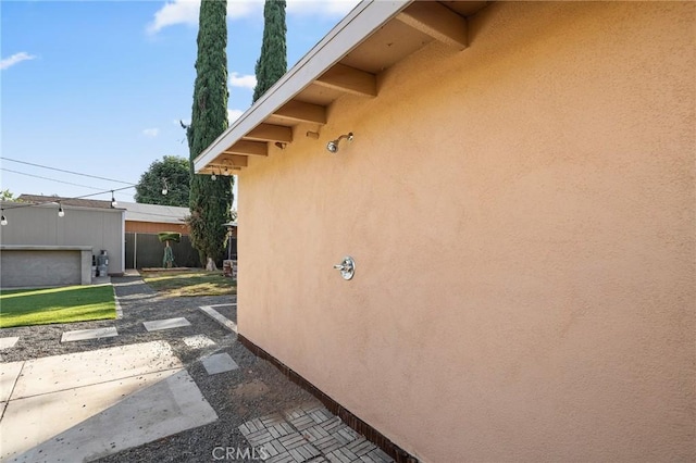 8626 Stark St, Riverside, CA 92504 - view of side of home with stucco siding and a patio area