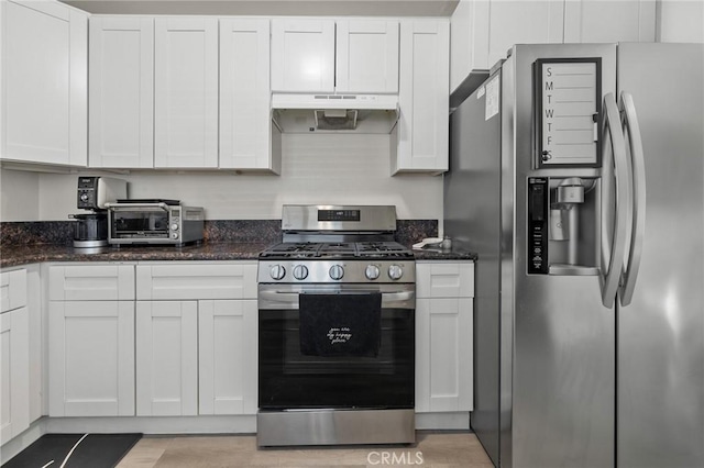 8626 Stark St, Riverside, CA 92504 - kitchen with stainless steel appliances, under cabinet range hood, white cabinetry, and dark stone countertops