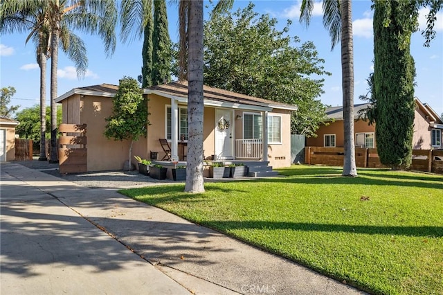 8626 Stark St, Riverside, CA 92504 - view of front of home featuring stucco siding, a front lawn, and a porch