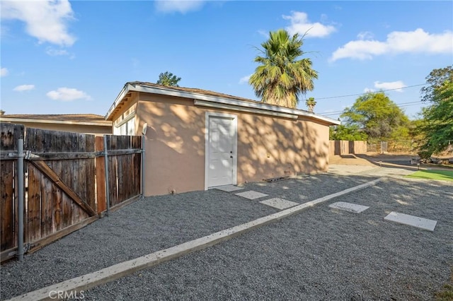 8626 Stark St, Riverside, CA 92504 - view of side of home with stucco siding, uncovered parking, and a gate