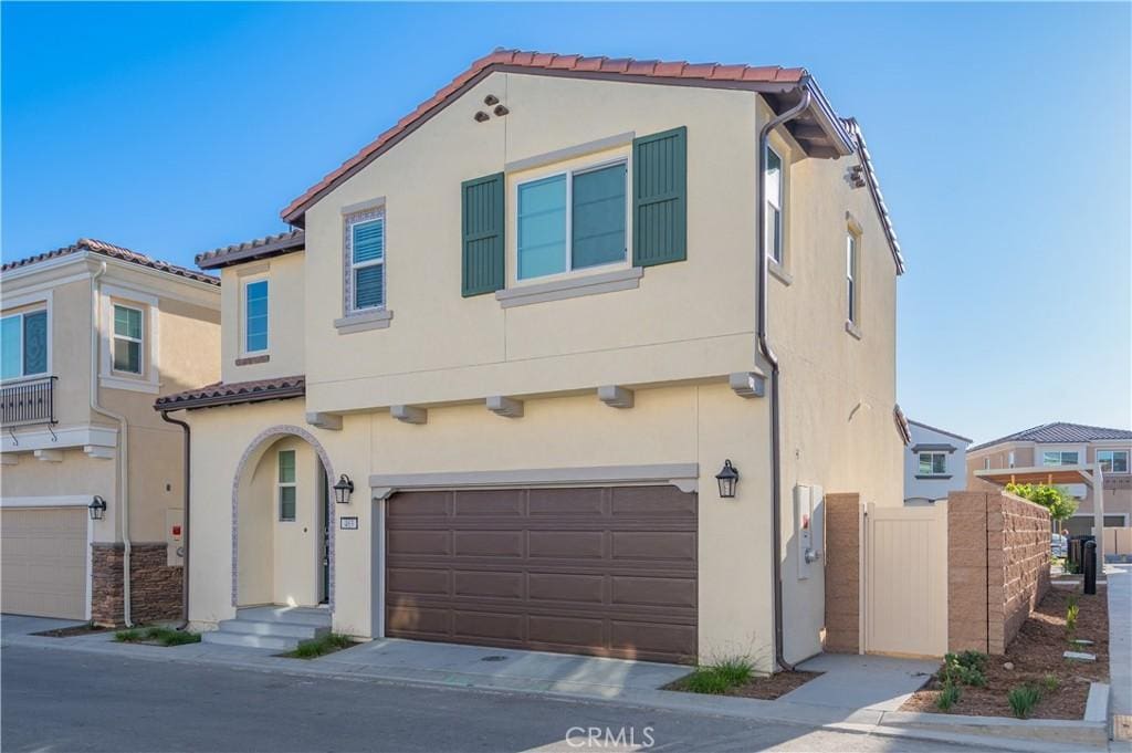 463 Meyer Pl, Upland, CA 91786 - mediterranean / spanish home featuring an attached garage, stucco siding, and a tiled roof