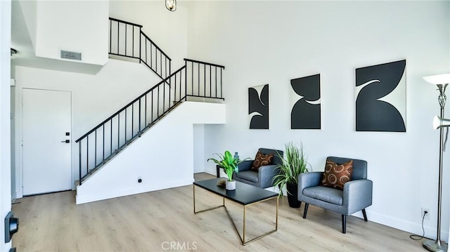 8810 Hewitt Pl Unit 2, Garden Grove, CA 92844 - living area featuring stairs, wood finished floors, and a towering ceiling