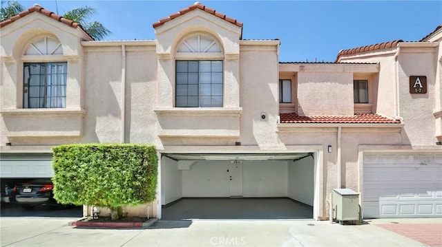 8810 Hewitt Pl Unit 2, Garden Grove, CA 92844 - view of front facade with a tile roof, stucco siding, a garage, and driveway