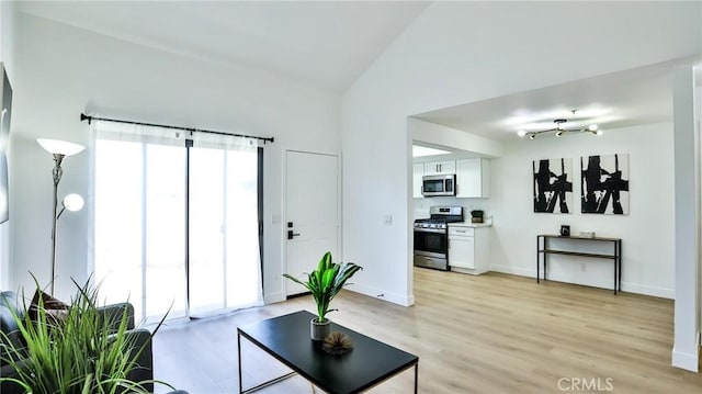 8810 Hewitt Pl Unit 2, Garden Grove, CA 92844 - living room with light wood-style floors and lofted ceiling