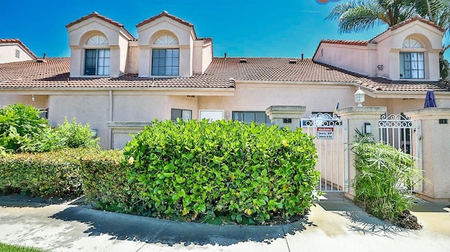 8810 Hewitt Pl Unit 2, Garden Grove, CA 92844 - mediterranean / spanish home with a tiled roof, a gate, and stucco siding