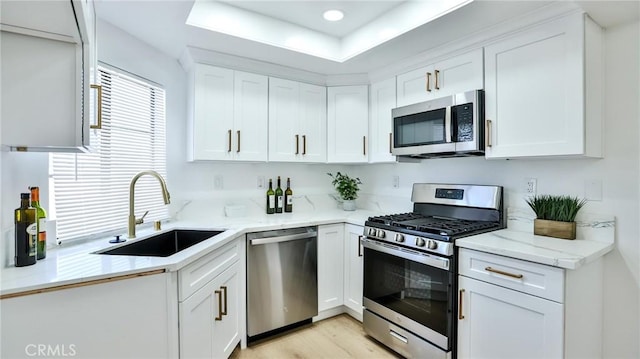 8810 Hewitt Pl Unit 2, Garden Grove, CA 92844 - kitchen featuring stainless steel appliances, white cabinetry, light stone counters, light wood-style floors, and recessed lighting