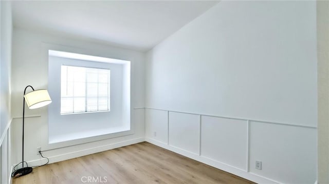 8810 Hewitt Pl Unit 2, Garden Grove, CA 92844 - unfurnished room featuring wood finished floors, wainscoting, and a decorative wall