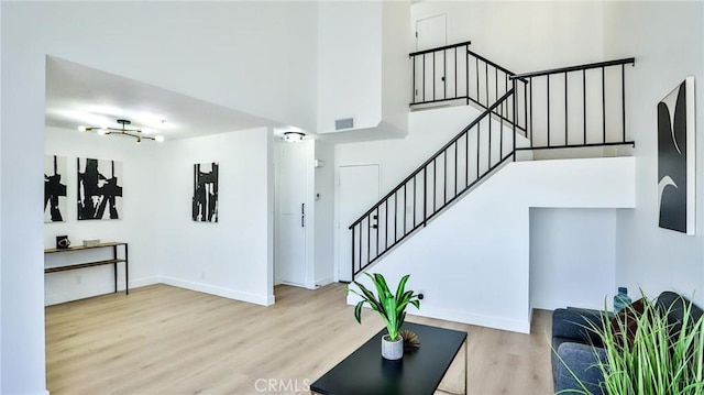 8810 Hewitt Pl Unit 2, Garden Grove, CA 92844 - living area with stairway, wood finished floors, and a high ceiling