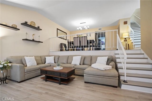 18230 Oxnard St Unit 110, Tarzana, CA 91356 - living room with stairway, wood finished floors, a chandelier, and lofted ceiling