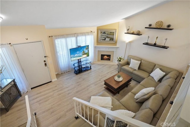 18230 Oxnard St Unit 110, Tarzana, CA 91356 - living room featuring light wood finished floors and a fireplace with flush hearth