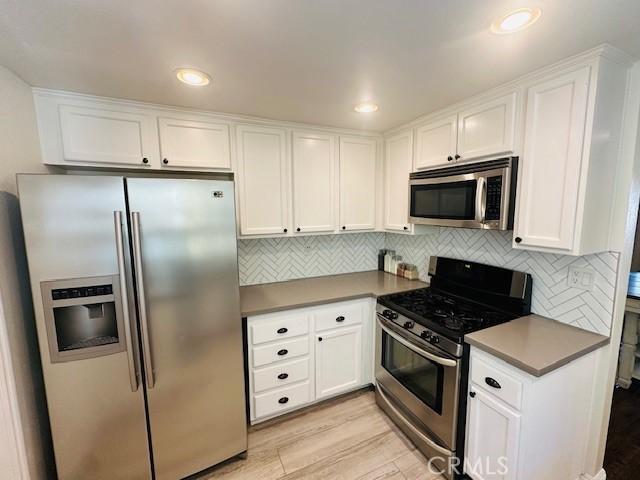 6080 Cape Cod Ln Unit 54, Yorba Linda, CA 92887 - kitchen featuring stainless steel appliances, white cabinetry, backsplash, and recessed lighting