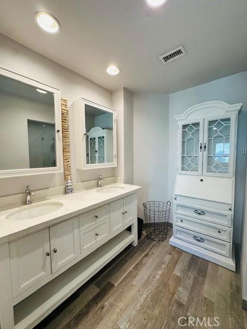 6080 Cape Cod Ln Unit 54, Yorba Linda, CA 92887 - full bath with double vanity, wood finished floors, and recessed lighting