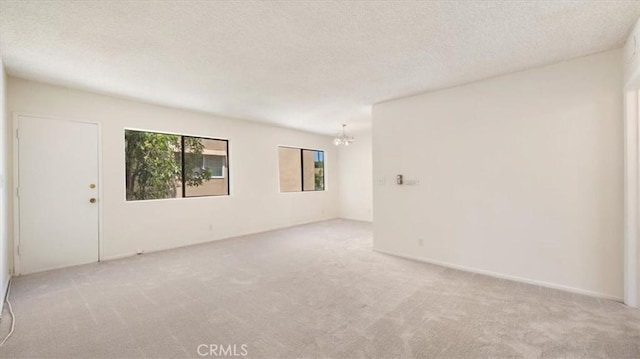 1115 Cordova St Unit 207, Pasadena, CA 91106 - carpeted empty room featuring a chandelier and a textured ceiling