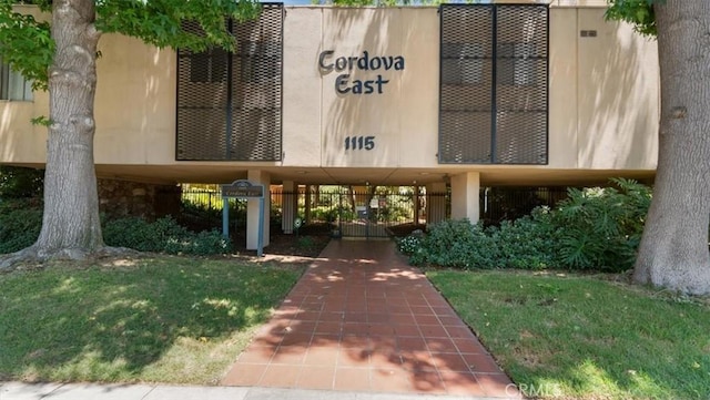 1115 Cordova St Unit 207, Pasadena, CA 91106 - view of exterior entry featuring a lawn