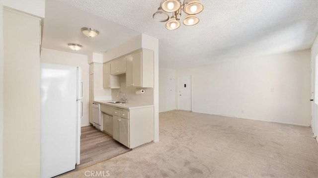 1115 Cordova St Unit 207, Pasadena, CA 91106 - kitchen with white appliances, light countertops, light carpet, a chandelier, and a textured ceiling