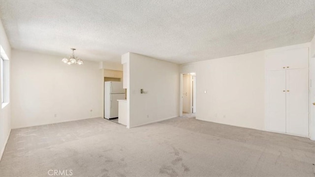 1115 Cordova St Unit 207, Pasadena, CA 91106 - unfurnished room featuring a chandelier, light carpet, and a textured ceiling