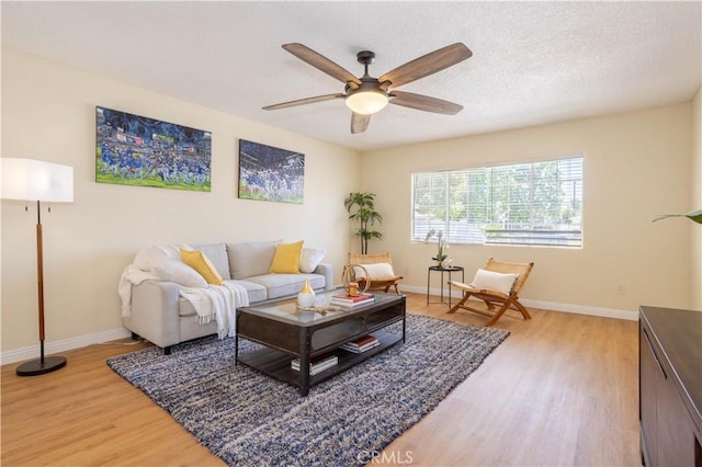 8825 Sophia Ave, North Hills, CA 91343 - living room with light wood-style floors, a ceiling fan, and a textured ceiling
