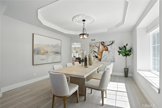 20455 Via Canarias, Yorba Linda, CA 92887 - dining area featuring a tray ceiling, healthy amount of natural light, light wood-style flooring, and crown molding