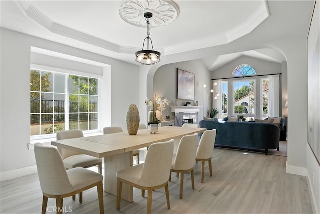 20455 Via Canarias, Yorba Linda, CA 92887 - dining room with arched walkways, ornamental molding, a raised ceiling, light wood-style floors, and a fireplace