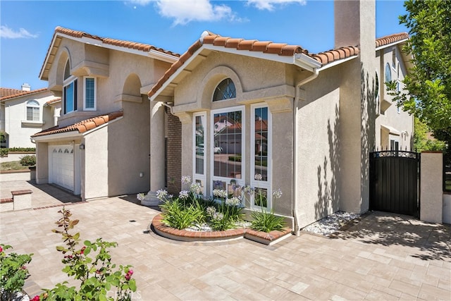 20455 Via Canarias, Yorba Linda, CA 92887 - mediterranean / spanish-style home with a tile roof, stucco siding, a gate, and an attached garage