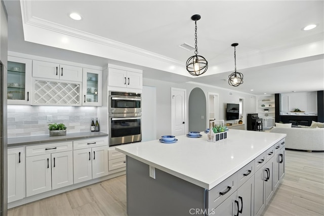 20455 Via Canarias, Yorba Linda, CA 92887 - kitchen with stainless steel double oven, recessed lighting, arched walkways, tasteful backsplash, and a raised ceiling
