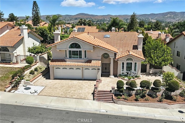 20455 Via Canarias, Yorba Linda, CA 92887 - mediterranean / spanish-style house with a tile roof, stucco siding, driveway, a garage, and a mountain view