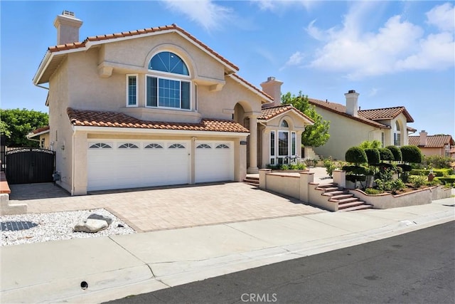 20455 Via Canarias, Yorba Linda, CA 92887 - mediterranean / spanish home with a garage, a chimney, stucco siding, a gate, and decorative driveway