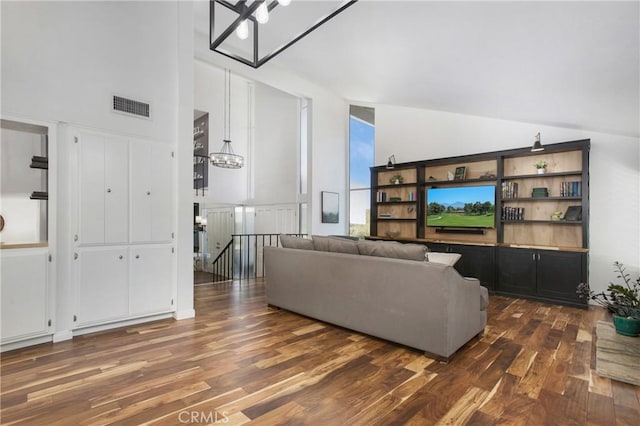 25632 Adriana St, Mission Viejo, CA 92691 - living area featuring a chandelier, dark wood-style flooring, and a towering ceiling