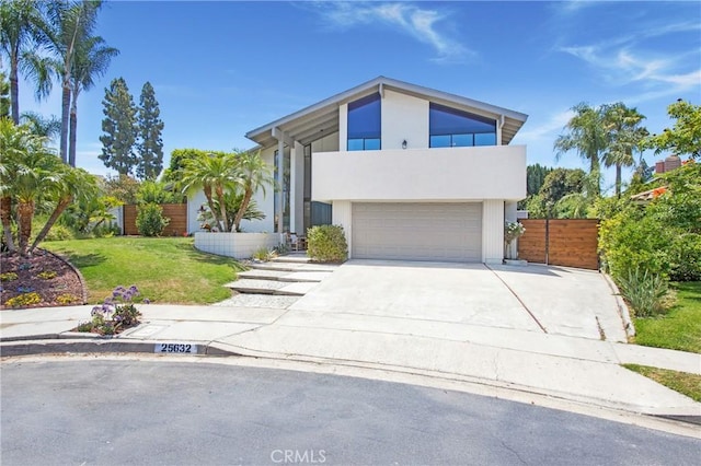 25632 Adriana St, Mission Viejo, CA 92691 - view of front of property featuring an attached garage, concrete driveway, a balcony, and stucco siding