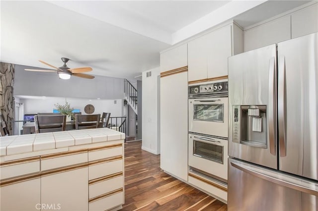 25632 Adriana St, Mission Viejo, CA 92691 - kitchen with stainless steel fridge with ice dispenser, double oven, ceiling fan, wood finished floors, and tile counters