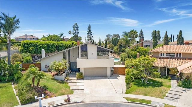 25632 Adriana St, Mission Viejo, CA 92691 - view of front of home featuring concrete driveway, an attached garage, stucco siding, and a front lawn