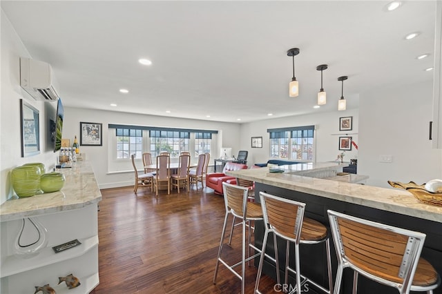 2115 Kathryn Way, Placentia, CA 92870 - kitchen featuring an AC wall unit, recessed lighting, dark wood-style flooring, a breakfast bar area, and hanging light fixtures