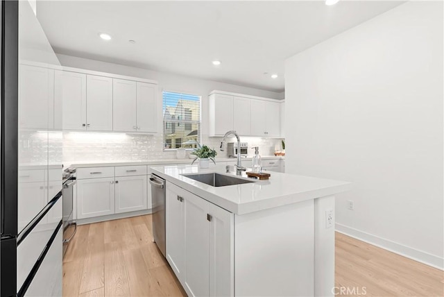 90 Harness Way, Rancho Mission Viejo, CA 92694 - kitchen with light wood-type flooring, a center island with sink, dishwasher, tasteful backsplash, and recessed lighting