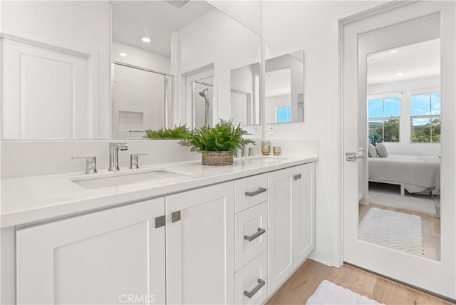 90 Harness Way, Rancho Mission Viejo, CA 92694 - ensuite bathroom featuring double vanity, a shower stall, wood finished floors, and recessed lighting