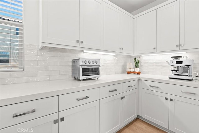 90 Harness Way, Rancho Mission Viejo, CA 92694 - kitchen featuring light countertops, tasteful backsplash, white cabinets, and light wood-style floors