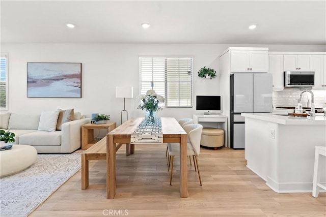 90 Harness Way, Rancho Mission Viejo, CA 92694 - kitchen featuring stainless steel microwave, freestanding refrigerator, light wood-style flooring, range, and decorative backsplash