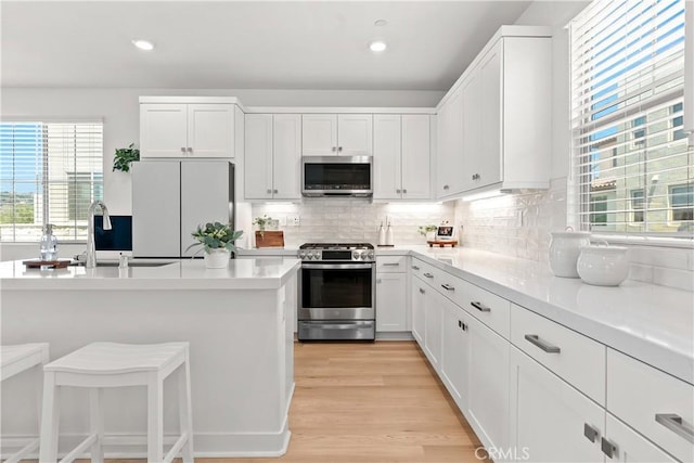 90 Harness Way, Rancho Mission Viejo, CA 92694 - kitchen with appliances with stainless steel finishes, white cabinets, backsplash, light countertops, and recessed lighting