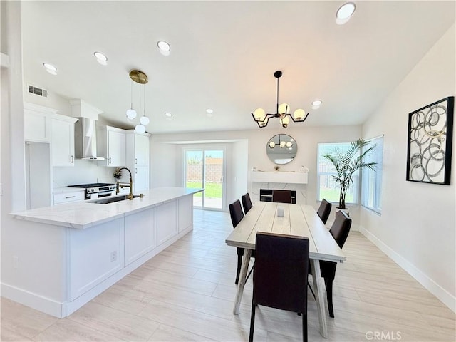 1421 Wildflower St, Rialto, CA 92377 - dining room featuring recessed lighting, light wood-type flooring, and a chandelier