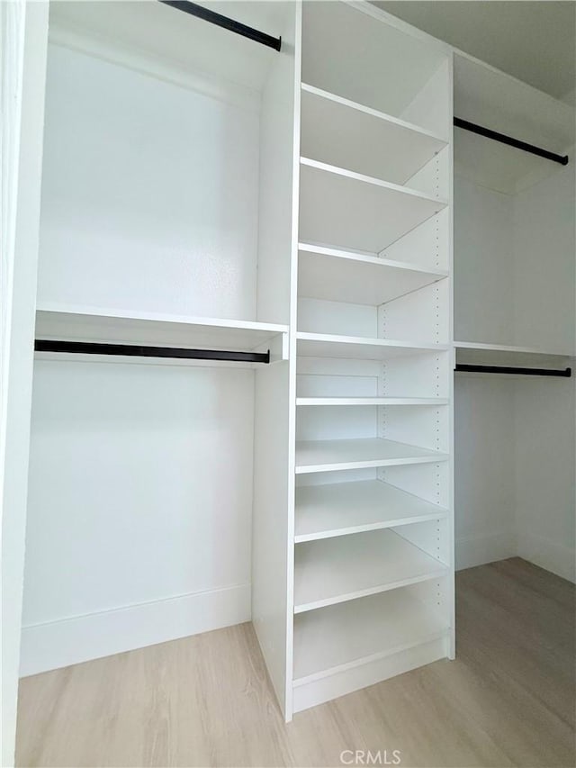 1421 Wildflower St, Rialto, CA 92377 - walk in closet featuring wood finished floors