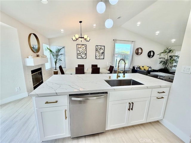 1421 Wildflower St, Rialto, CA 92377 - kitchen with dishwasher, hanging light fixtures, white cabinetry, light stone counters, and lofted ceiling
