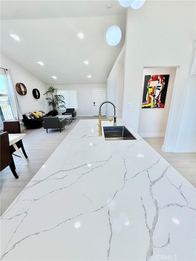1421 Wildflower St, Rialto, CA 92377 - kitchen featuring light stone countertops, light wood-style flooring, hanging light fixtures, and recessed lighting