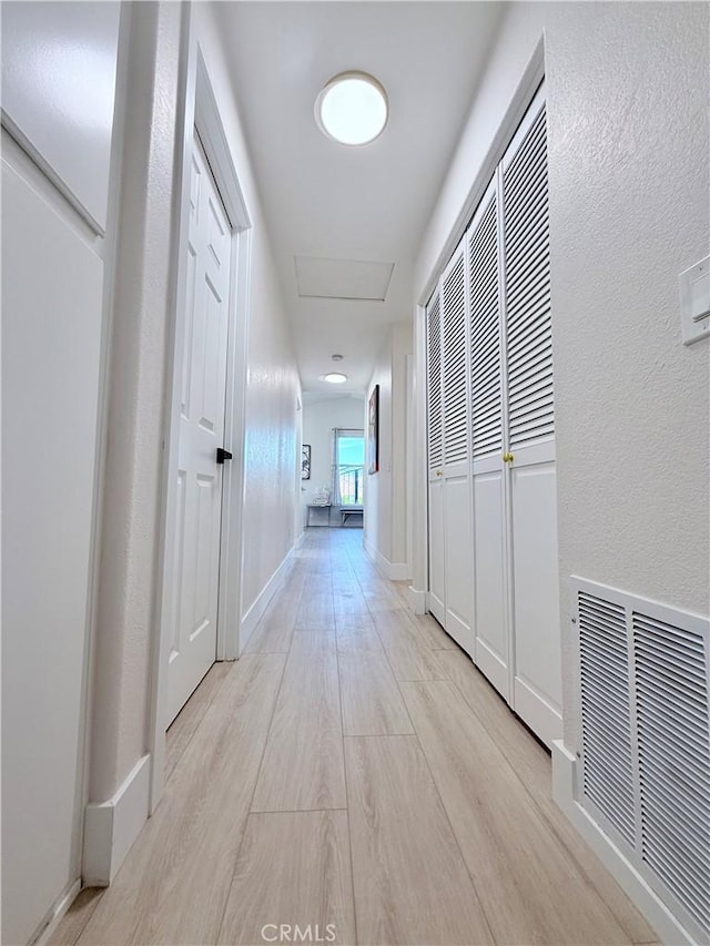 1421 Wildflower St, Rialto, CA 92377 - corridor with attic access and light wood-style floors