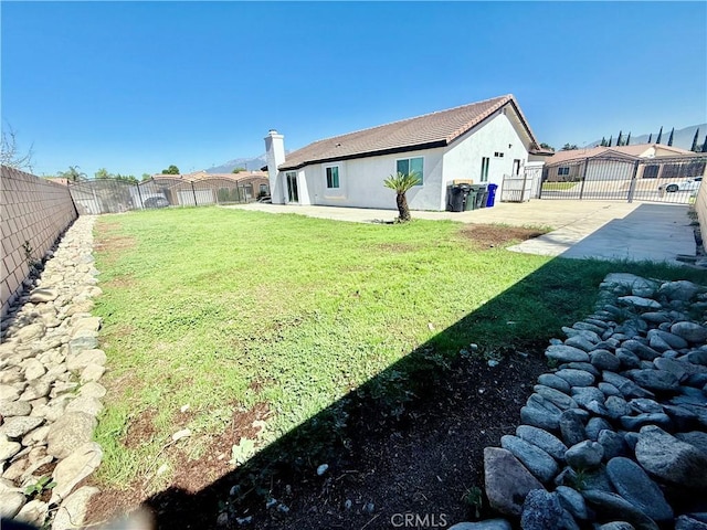 1421 Wildflower St, Rialto, CA 92377 - fenced backyard with a patio area and a gate