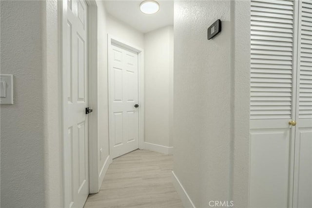 1421 Wildflower St, Rialto, CA 92377 - corridor with light wood-style floors and a textured wall