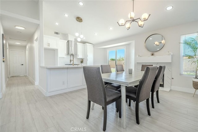 1421 Wildflower St, Rialto, CA 92377 - dining space featuring recessed lighting, a chandelier, vaulted ceiling, and light wood-style floors